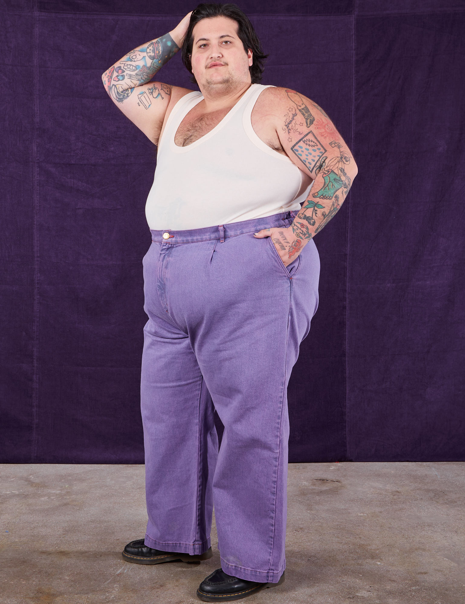 Angled view of Overdyed Wide Leg Trousers in Faded Grape and Tank Top in vintage tee off-white on Sam