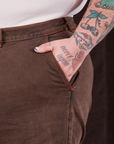 Overdyed Wide Leg Trousers in Brown front pocket close up. Sam has their hand in the pocket.