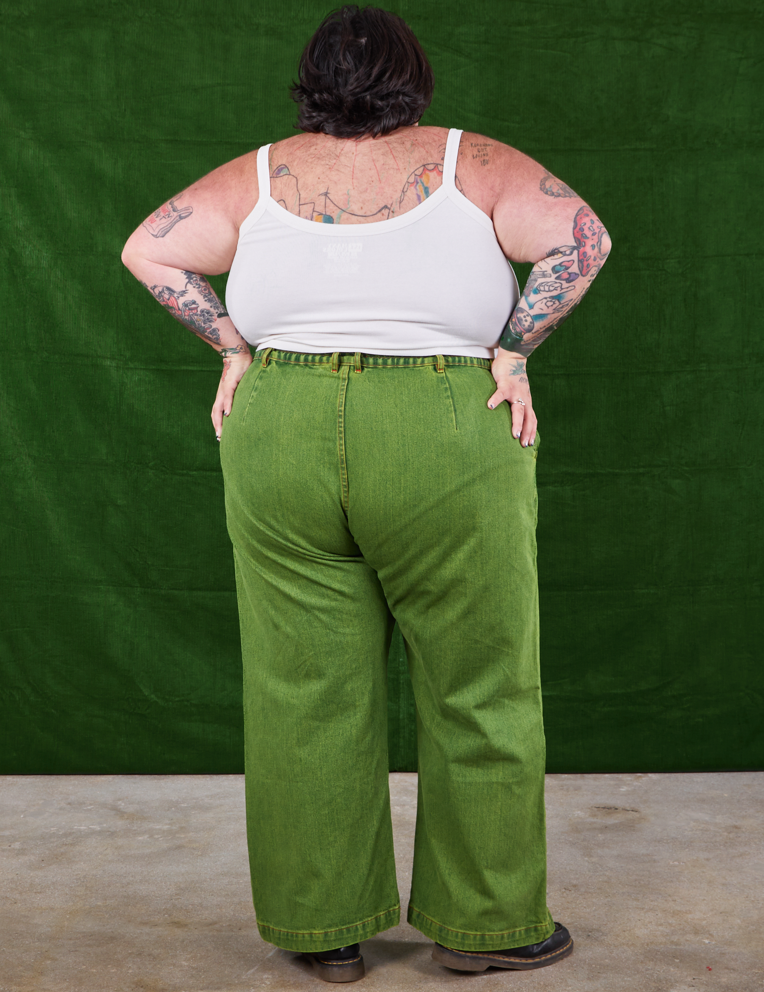 Back view of Overdyed Wide Leg Trousers in Gross Green and Cropped Cami in vintage tee off-white on Sam