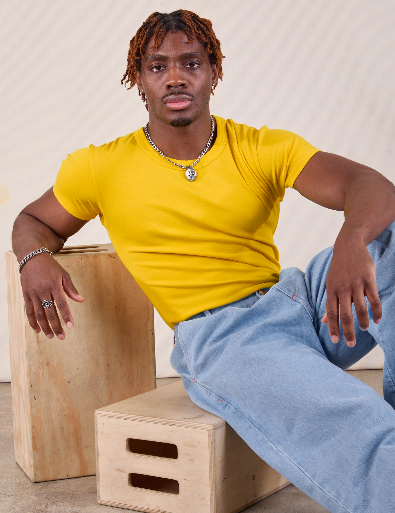 Isaac is wearing Baby Tee in Golden Yellow