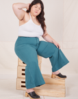 Ashley is wearing Petite Bell Bottoms in Marine Blue and Halter Top in vintage tee off-white