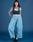 Sydney is 5’9” and wearing L Painted Drop Pocket Cargo Pants in Baby Blue paired with lagoon Mini Tank