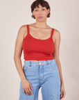 Tiara is 5'4" and wearing XS Cropped Cami in Mustang Red paired with light wash Sailor Jeans