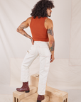 Back view of Carpenter Jeans in Vintage Off-White and burnt terracotta Cropped Tank Top on Jesse