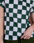 Front close up of Checker Organic Tee in Swamp Green on Alex