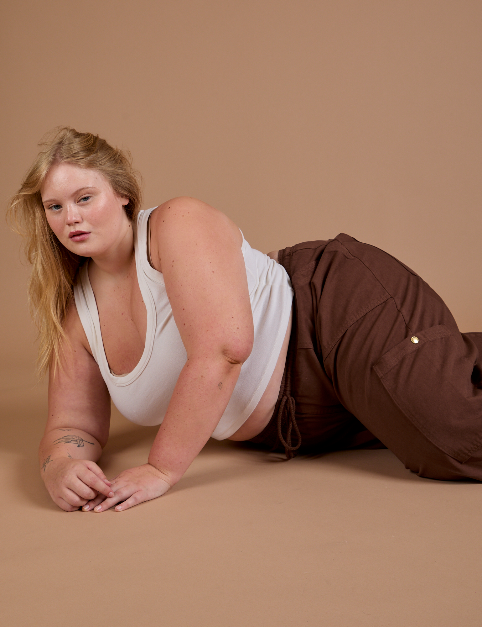 Juliet is wearing Drop Pocket Cargo Pants in Fudgesicle Brown and Cropped Tank in vintage tee white