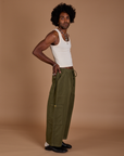 Side view of Drop Pocket Cargo Pants in Surplus Green and Tank Top in Vintage Tee White
