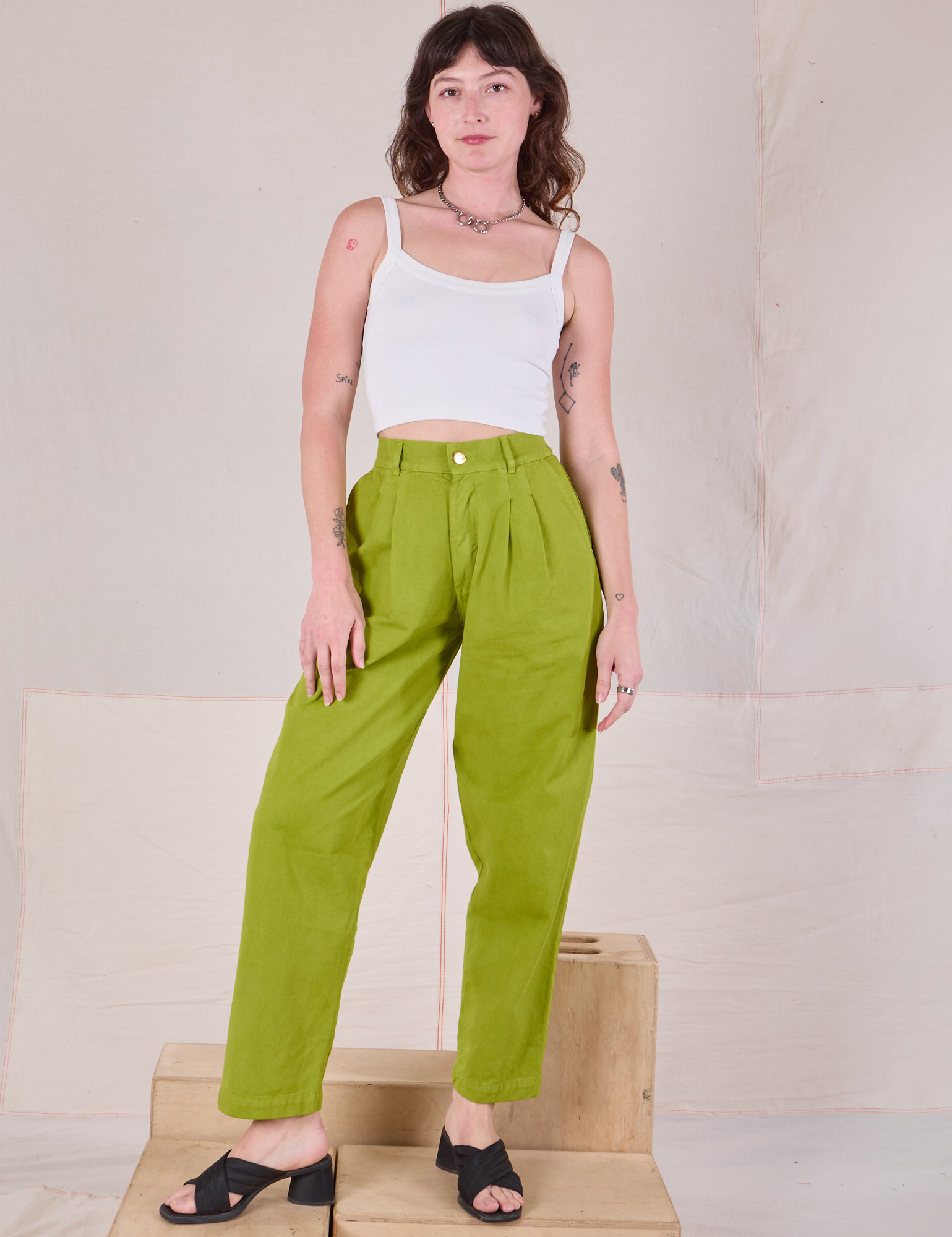Alex is 5'8" and wearing XXS Heavyweight Trousers in Gross Green paired with a Cami in vintage tee off-white