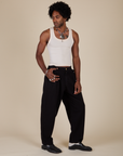 Angled front view of Heavyweight Trousers in Basic Black and Tank Top in Vintage Tee Off-White