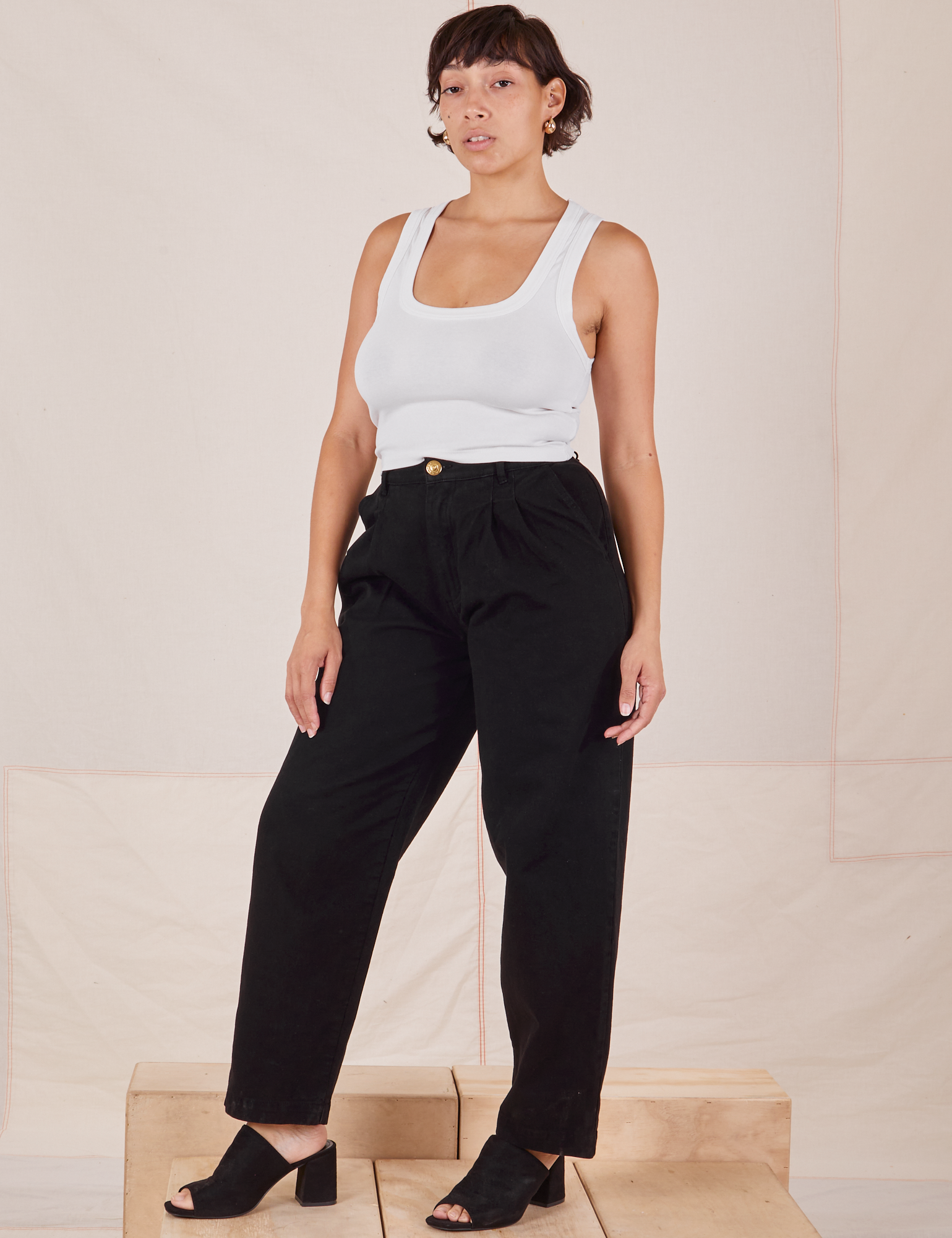 Tiara is 5&#39;4&quot; and wearing S Heavyweight Trousers in Basic Black paired with Cropped Tank Top in vintage tee off-white