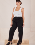 Tiara is 5'4" and wearing S Heavyweight Trousers in Basic Black paired with Cropped Tank Top in vintage tee off-white