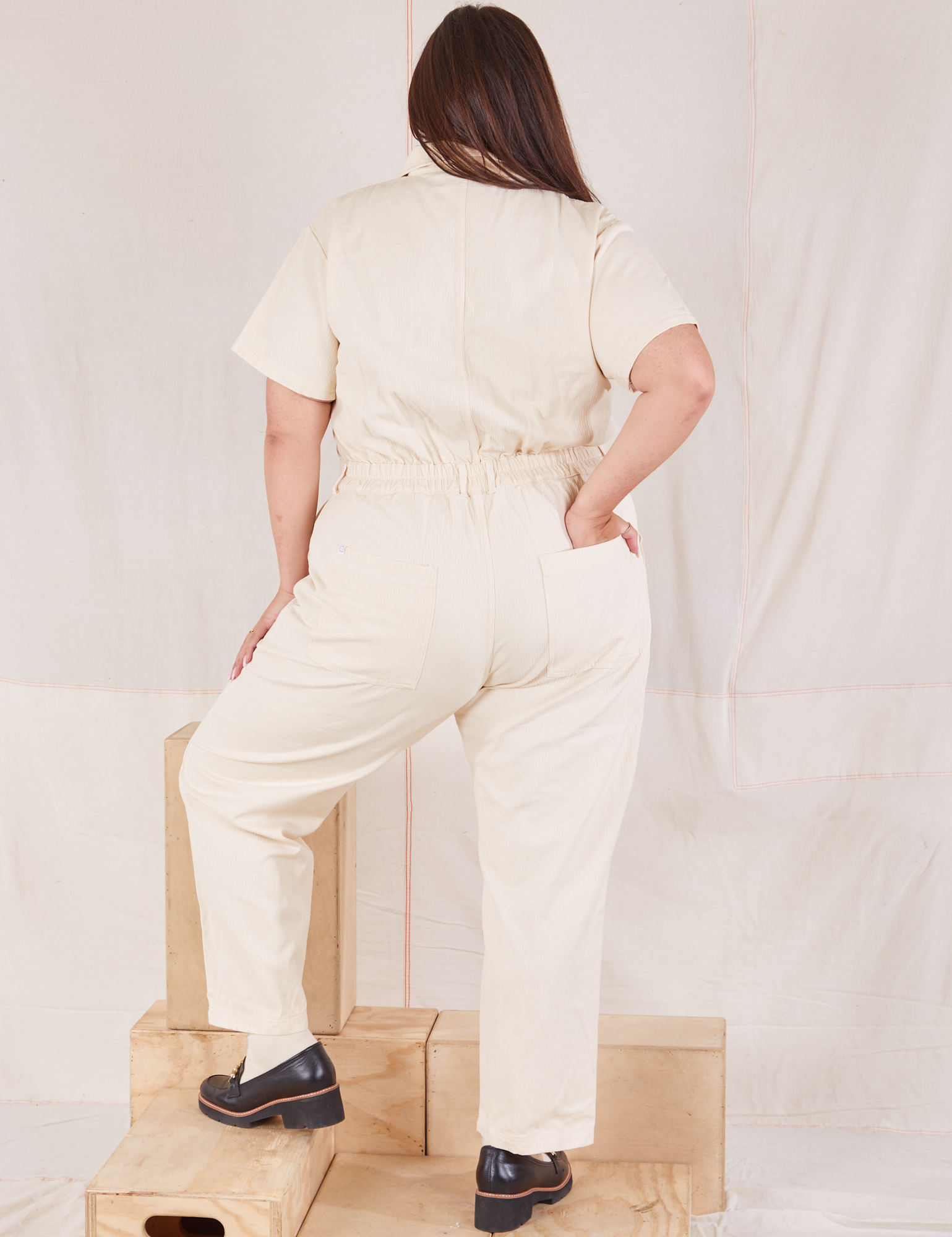 Heritage Short Sleeve Jumpsuit in Natural back view on Katie