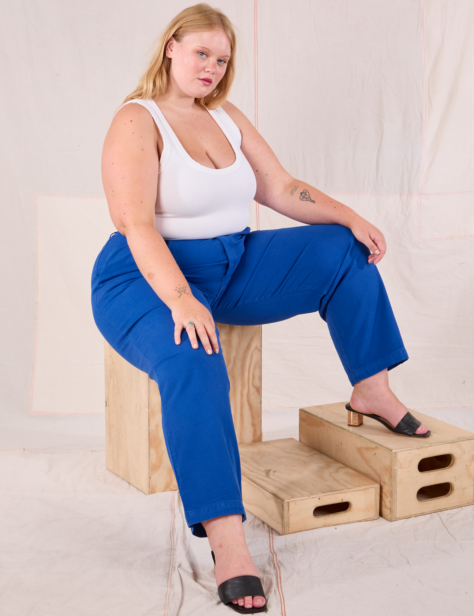 Juliet is wearing Heritage Trousers in Royal Blue and Cropped Tank in vintage tee off-white