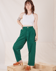 Hana is 5'3" and wearing XXS Petite Heavyweight Trousers in Hunter Green paired with Halter Top in vintage tee off-white