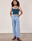 Jesse is wearing Cropped Cami in Lagoon and light wash Carpenter Jeans
