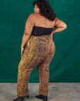 Angled back view of Leopard Work Pants and black Halter Top on Morgan