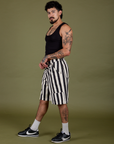 Side view of Longline Work Shorts in Natural and black Cropped Tank on Jesse