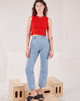 Alex is wearing Muscle Tee in Mustang Red and light wash Carpenter Jeans