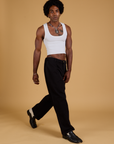 Angled front view of Baggy Mid-Rise Trousers in Basic Black and vintage tee white Cropped Tank