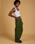 Side view of Baggy Mid-Rise Trousers in Evergreen and vintage tee white Cropped Tank on Jerrod