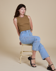 Alex is wearing Muscle Tee in Desert Brown and light wash Carpenter Jeans