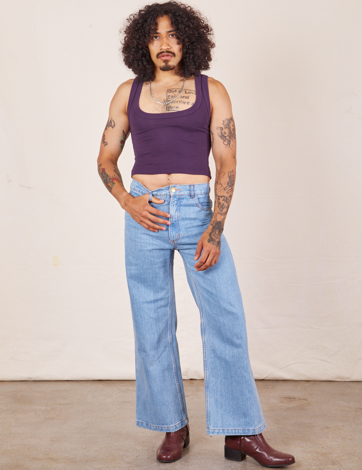 Jesse is wearing Cropped Tank Top in Nebula Purple and light wash Sailor Jeans