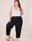 Ashley is 5'7" and wearing 1XL Petite Organic Trousers in Basic Black paired with Cropped Tank Top in vintage tee off-white