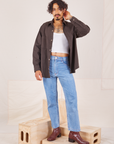 Jesse is wearing Oversize Overshirt in Espresso Brown, vintage off-white Cropped Tank Top and light wash Frontier Jeans