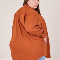 Angled back view of Oversize Overshirt in Burnt Terracotta worn by Marielena