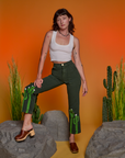 Alex is wearing Paintstamped Work Pants in Cactus and Cropped Tank in Vintage Tee White