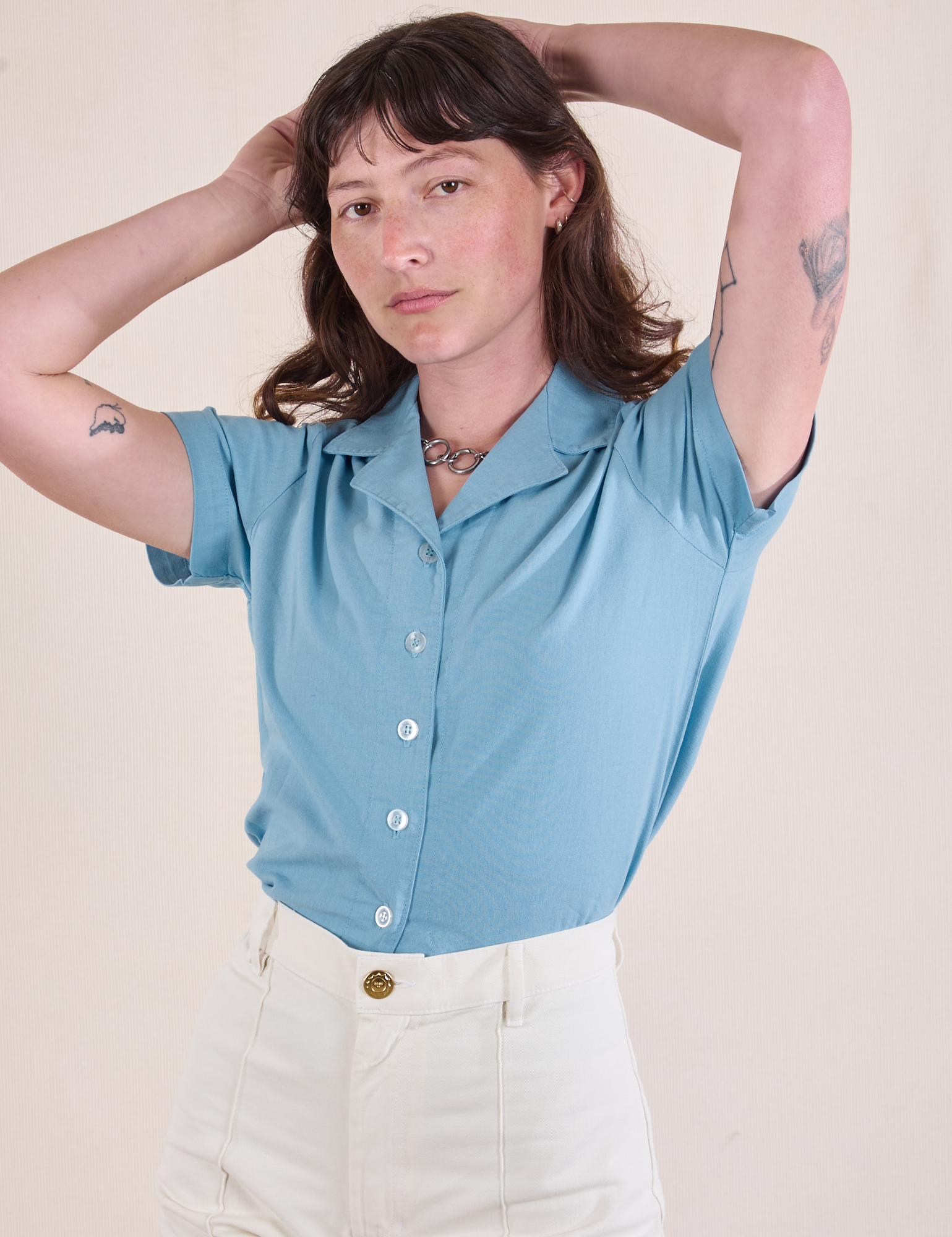 Alex is 5'8" and wearing P Pantry Button-Up in Baby Blue