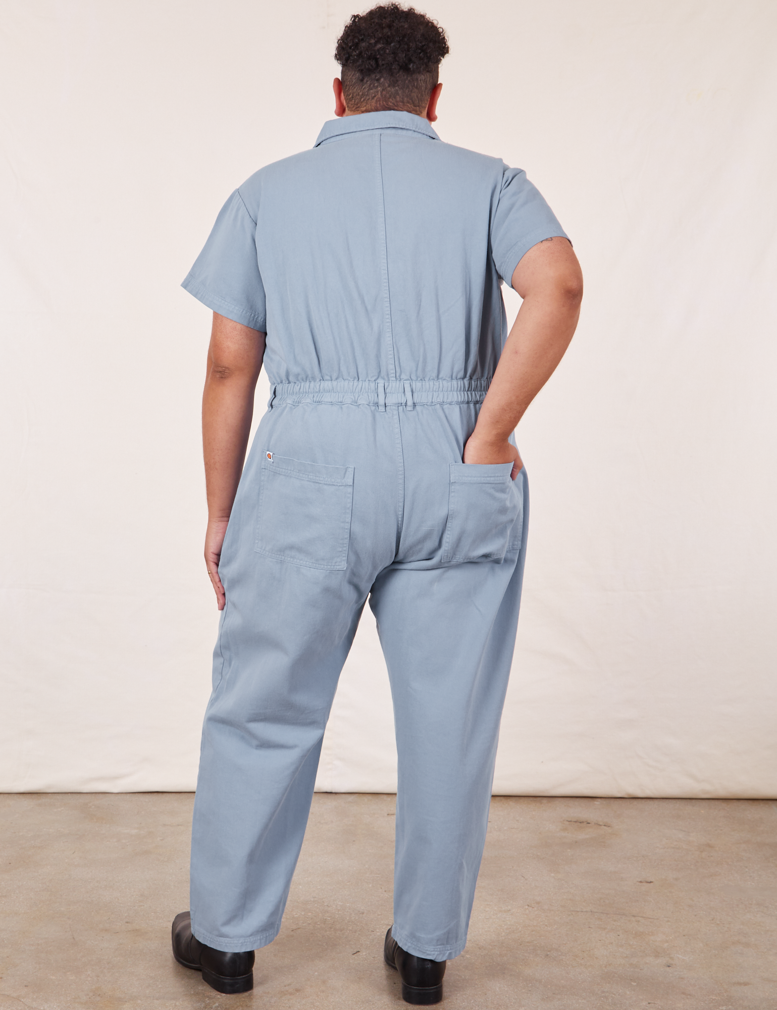 Back view of Short Sleeve Jumpsuit in Periwinkle on Miguel.
