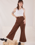 Hana is 5'3" and wearing P Petite Bell Bottoms in Fudgesicle Brown paired with a Halter Top in vintage tee off-white