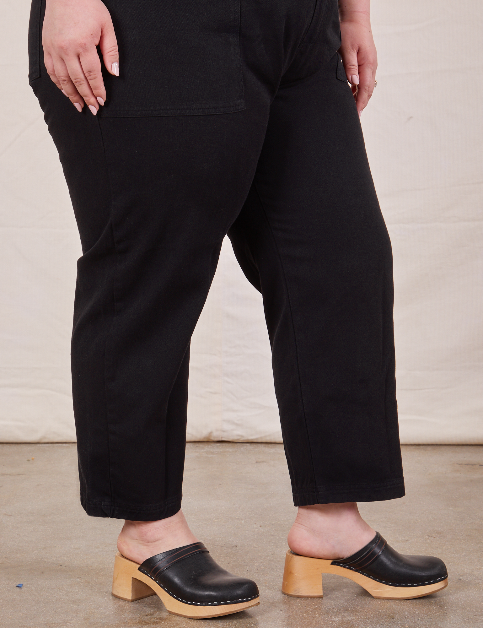 Pant leg close up of Petite Short Sleeve Jumpsuit in Basic Black worn by Ashley