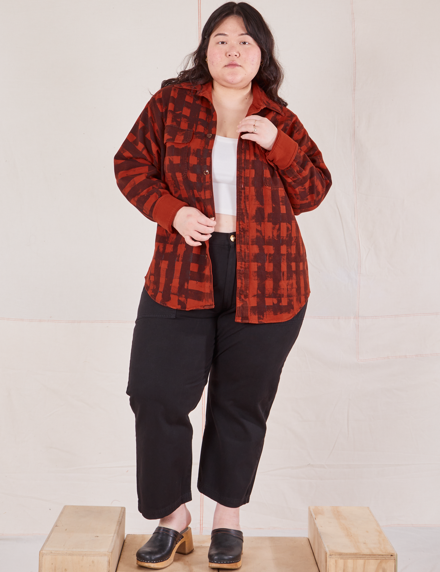 Ashley is 5&#39;7&quot; and wearing M Plaid Flannel Overshirt in Paprika paired with black Work Pants