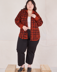 Ashley is 5'7" and wearing M Plaid Flannel Overshirt in Paprika paired with black Work Pants