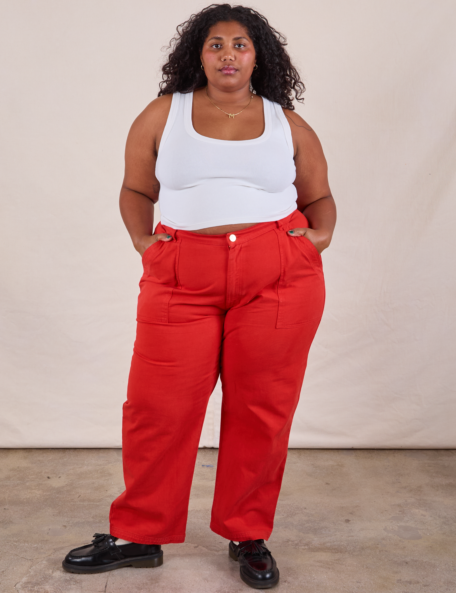 Morgan is 5'5" and wearing 2XL Work Pants in Mustang Red paired with a Cropped Tank in Vintage Tee Off-White