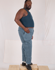 Side view of Railroad Carpenter Jeans in Baby Blue and marine blue Muscle Tee on Elijah
