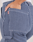 Carpenter Jeans in Indigo Railroad back pocket close up. Tiara has her hand in the pocket.