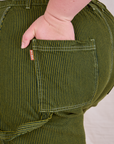 Close up of Ashley's hand in the back pocket of Railroad Carpenter Shorts in Summer Olive