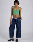Kira is wearing Tank Top in Seafoam Green and dark wash Denim Drop Pocket Pants