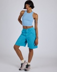 Kira is 5’10” and wearing XS Longline Work Shorts in Hawaiian Blue paired with a baby blue Racerback Tank
