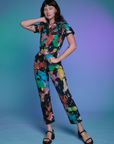 Alex is 5'8" and wearing XS Short Sleeve Jumpsuit in Rainbow Magic Waters