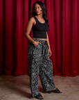 Side view of Drop Pocket Cargo Pants in Spider Webs and black Cropped Tank on Kandia