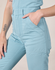 Short Sleeve Jumpsuit in Baby Blue side close up with Alex's hand in the pocket