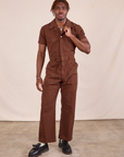 Issac is 5'10" and wearing M Short Sleeve Jumpsuit in Fudgesicle Brown