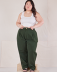 Ashley is wearing Heritage Trousers in Swamp Green and Cropped Tank Top in vintage tee off-white