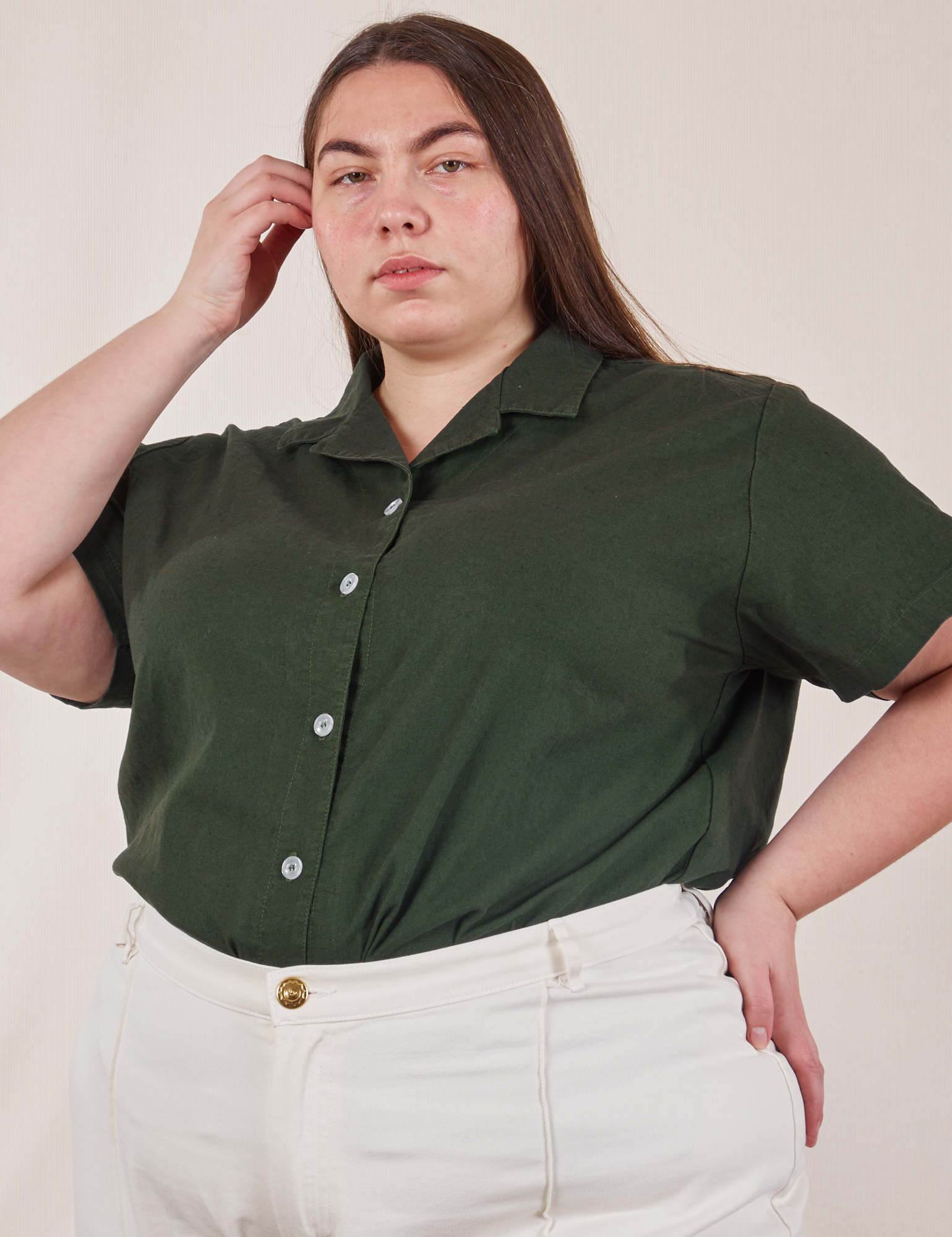 Marielena is wearing Pantry Button-Up in Swamp Green tucked into vintage tee off-white Western Pants