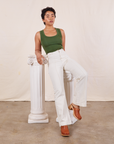 Mika is wearing Tank Top in Dark Emerald Green and vintage off-white Western Pants