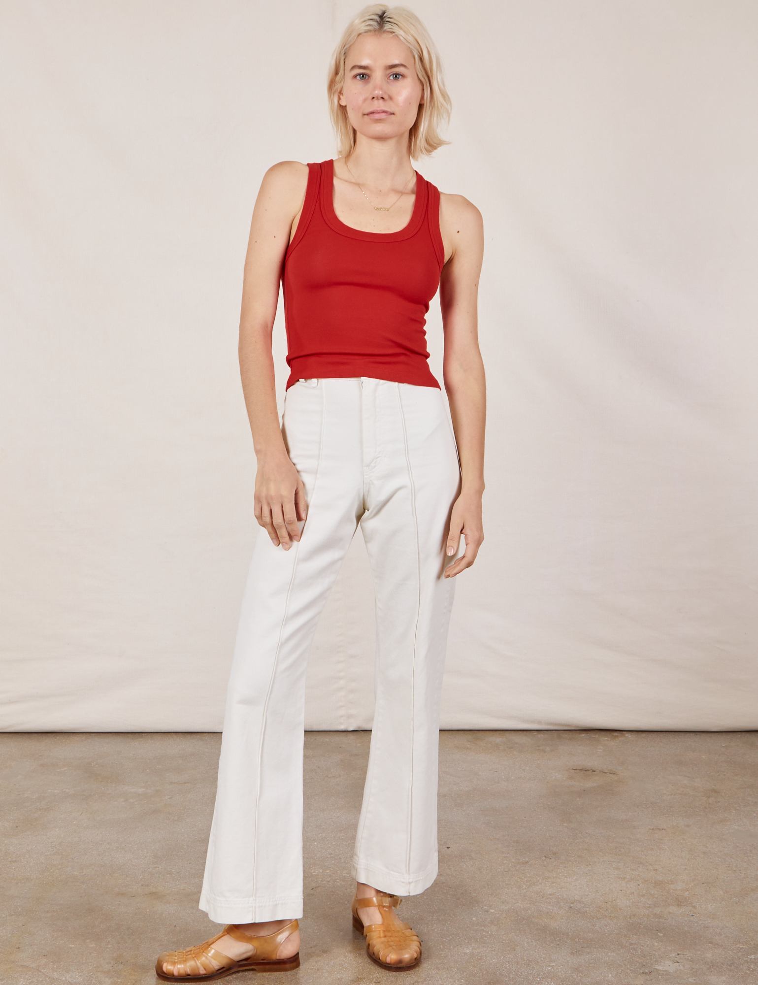 Madeline is 5&#39;9&quot; and wearing P Tank Top in Mustang Red paired with vintage tee off-white Western Pants